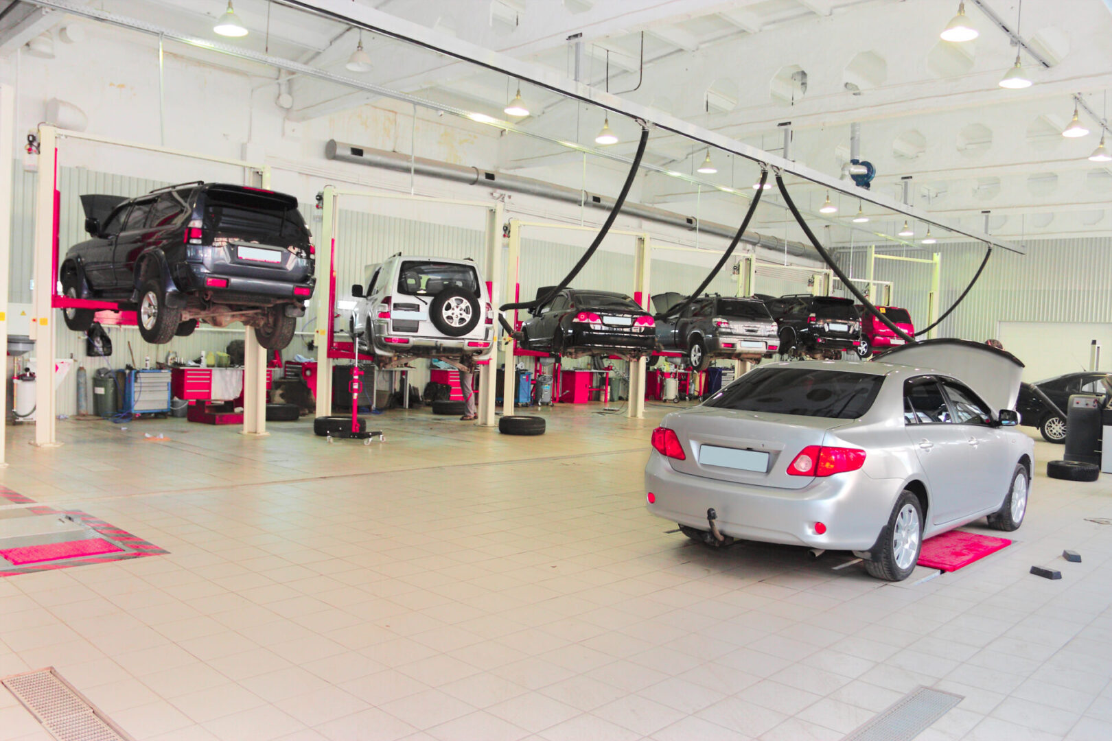 repair garage Car repair shop with vehicles on lifts.
